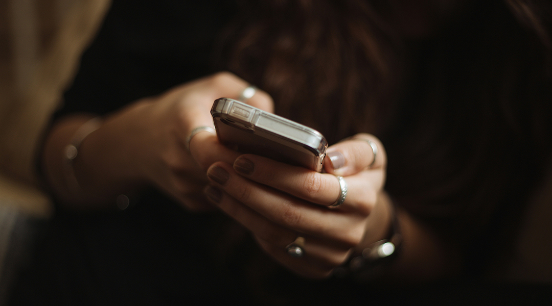 A woman holding a phone in her hands.