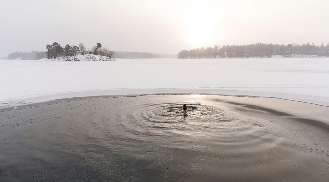 A woman taking a cold plunge.